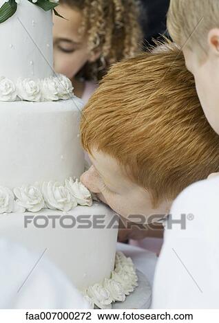 Boy eating wedding cake View Large Photo Image Stock Image - Boy eating wedding cake. Fotosearch