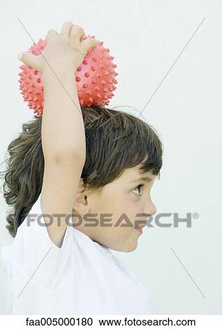 Boy holding ball on top of head, side view View Large Photo Image Stock Image - Boy holding ball on top of head, side view. Fotosearch