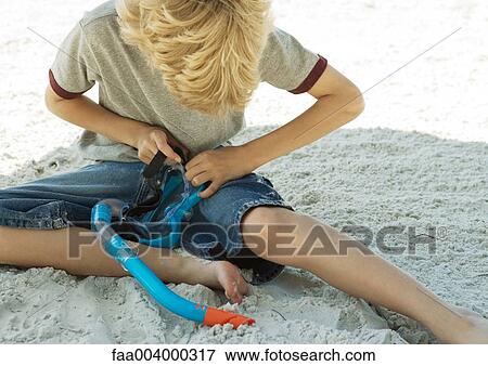 Boy sitting with snorkel and mask View Large Photo Image Stock Photo - Boy sitting with snorkel and mask. Fotosearch
