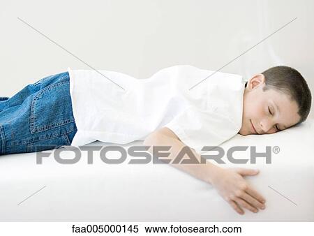Stock Photography - Boy sleeping on sofa. Fotosearch