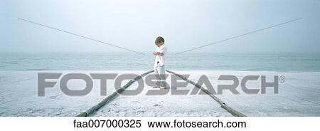 Boy standing in path on beach, folding arms View Large Photo Image Stock Photography - Boy standing in path on beach, folding arms. Fotosearch