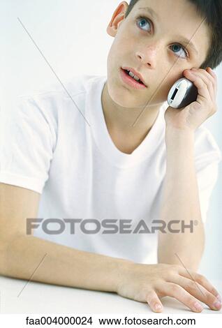 Picture - Boy using cell phone. Fotosearch