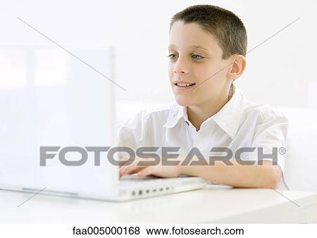 Boy using laptop View Large Photo Image Stock Photo - Boy using laptop. Fotosearch