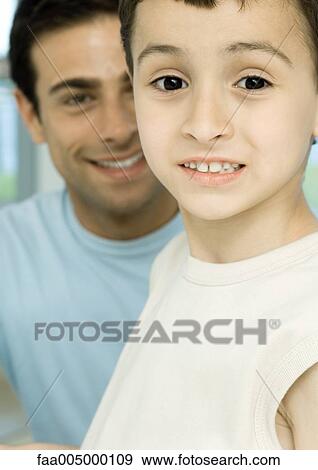 Stock Photo - Boy with father in background, portrait. Fotosearch