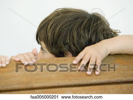 Boy with hands on edge of wooden plank, turning away View Large Photo Image Stock Image - Boy with hands on edge of wooden plank, turning away. Fotosearch