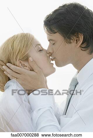 Bride and groom kissing, portrait View Large Photo Image Stock Photo - Bride and groom kissing, portrait. Fotosearch