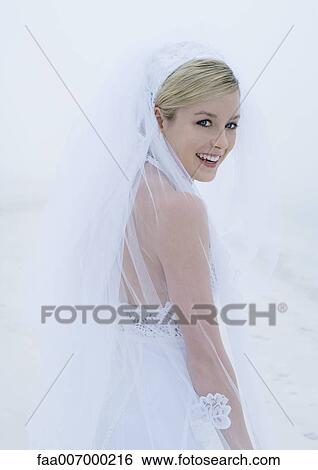 Stock Photograph - Bride looking over shoulder at camera. Fotosearch