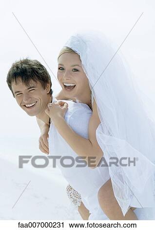 Bride riding piggyback on groom's back View Large Photo Image Stock Image - Bride riding piggyback on groom's back. Fotosearch