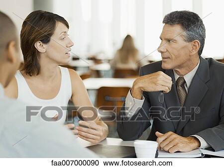 Business colleagues talking in cafeteria View Large Photo Image Stock Image - Business colleagues talking in cafeteria. Fotosearch