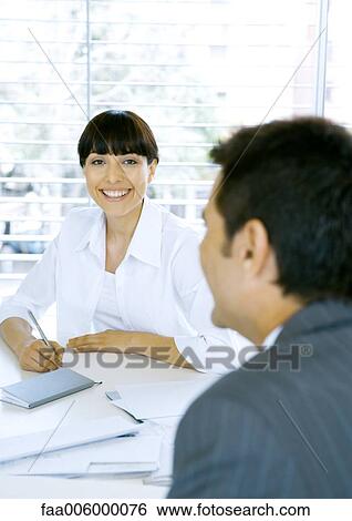 Business meeting, woman smiling at camera View Large Photo Image Stock Photograph - Business meeting, woman smiling at camera. Fotosearch