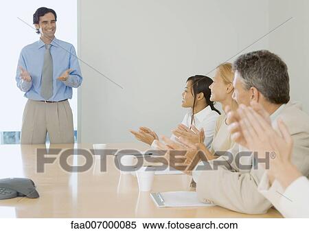 Business team applauding colleague View Large Photo Image Stock Photography - Business team applauding colleague. Fotosearch