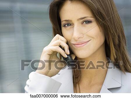 Stock Photograph - Business woman using cell phone. Fotosearch
