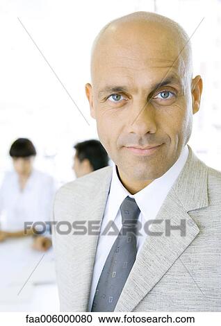 Stock Image - Businessman, looking at camera, portrait. Fotosearch