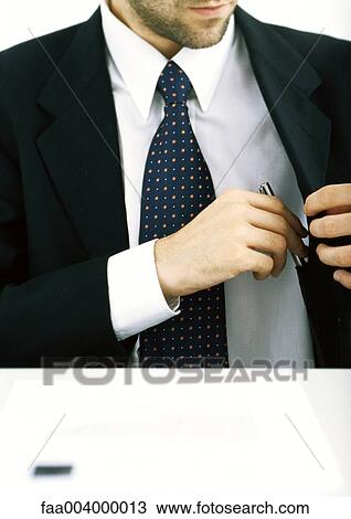 Businessman putting pen into jacket pocket View Large Photo Image Stock Image - Businessman putting pen into jacket pocket. Fotosearch