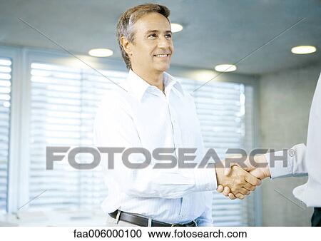 Stock Image - Businessman shaking hands. Fotosearch