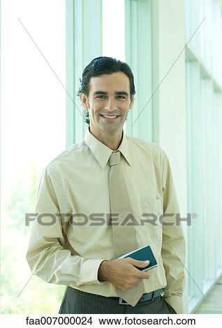 Businessman smiling at camera View Large Photo Image Picture - Businessman smiling at camera. Fotosearch