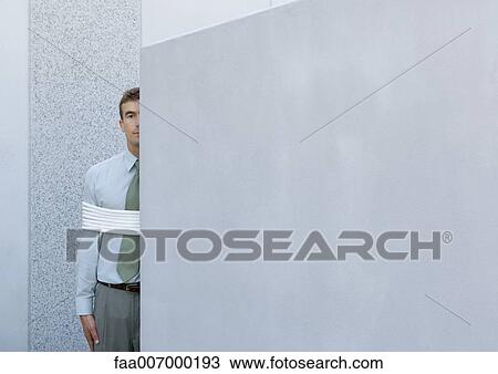 Businessman tied up, standing partially hidden behind wall View Large Photo Image Stock Image - Businessman tied up, standing partially hidden behind wall. Fotosearch