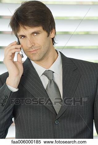 Stock Photography - Businessman using cell phone. Fotosearch