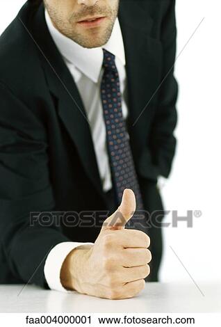 Businessman with fist on table giving thumbs up, cropped View Large Photo Image Stock Image - Businessman with fist on table giving thumbs up, cropped. Fotosearch