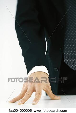 Stock Photograph - Businessman with hand on table. Fotosearch