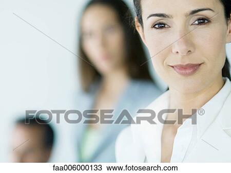 Businesswoman, colleagues in background View Large Photo Image Stock Image - Businesswoman, colleagues in background. Fotosearch