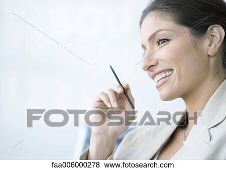 Businesswoman holding stylus, smiling View Large Photo Image Stock Photo - Businesswoman holding stylus, smiling. Fotosearch