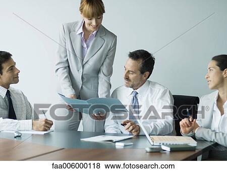 Businesswoman showing file in meeting View Large Photo Image Stock Photo - Businesswoman showing file in meeting. Fotosearch