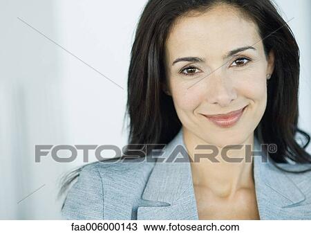 Businesswoman smiling at camera, portrait View Large Photo Image Stock Image - Businesswoman smiling at camera, portrait. Fotosearch