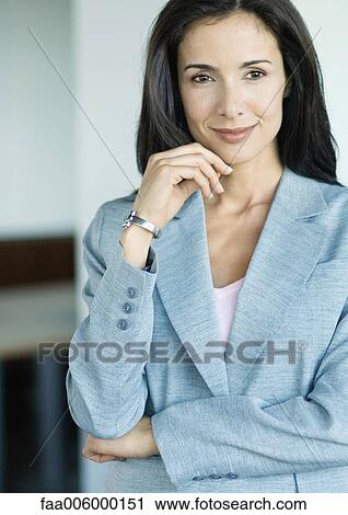 Stock Image - Businesswoman smiling at camera, portrait. Fotosearch