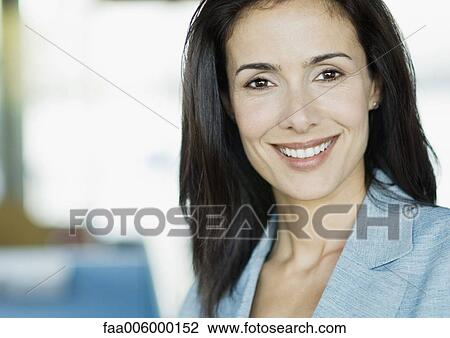 Stock Image - Businesswoman smiling at camera, portrait. Fotosearch