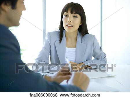 Businesswoman speaking to colleague View Large Photo Image Stock Photo - Businesswoman speaking to colleague. Fotosearch