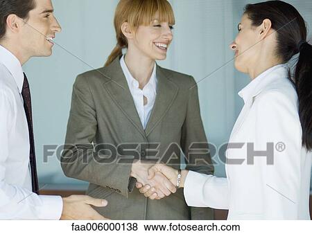 Stock Photo - Businesswomen shaking hands. Fotosearch