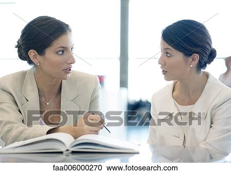 Stock Image - Businesswomen working together. Fotosearch