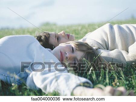 Children lying in grass View Large Photo Image Stock Photograph - Children lying in grass. Fotosearch