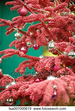 Christmas decorations on red christmas tree, close-up View Large Photo Image Stock Photo - Christmas decorations on red christmas tree, close-up. Fotosearch