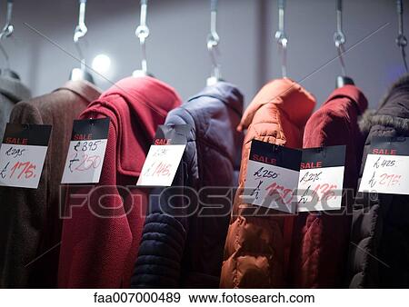 Coats on rack with tags showing sale prices View Large Photo Image Stock Photo - Coats on rack with tags showing sale prices. Fotosearch