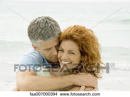Couple embracing on beach View Large Photo Image Picture - Couple embracing on beach. Fotosearch