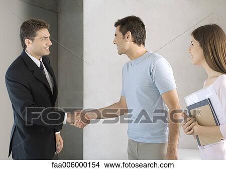 Couple greeting salesman View Large Photo Image Picture - Couple greeting salesman. Fotosearch