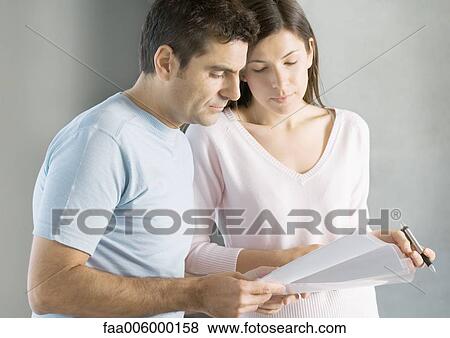 Stock Photo - Couple looking at documents. Fotosearch