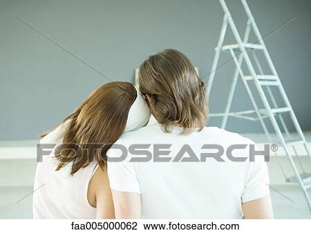 Couple looking at painted wall, rear view View Large Photo Image Stock Image - Couple looking at painted wall, rear view. Fotosearch