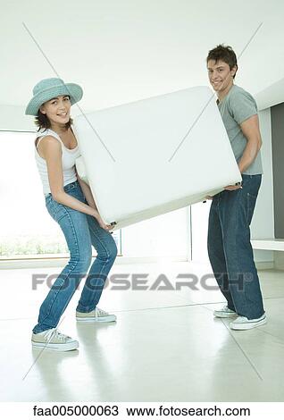 Couple moving armchair View Large Photo Image Stock Image - Couple moving armchair. Fotosearch