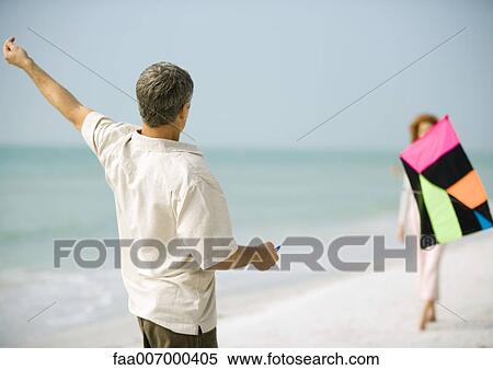Couple with kite on beach View Large Photo Image Stock Photography - Couple with kite on beach. Fotosearch