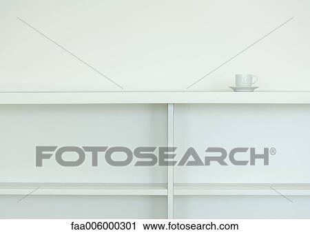 Cup and saucer on top of empty bookcase View Large Photo Image Stock Image - Cup and saucer on top of empty bookcase. Fotosearch
