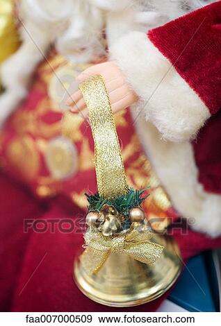 Decorative santa claus, close-up of hand holding bell View Large Photo Image Stock Photo - Decorative santa claus, close-up of hand holding bell. Fotosearch