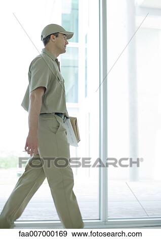 Delivery man walking View Large Photo Image Stock Photo - Delivery man walking. Fotosearch
