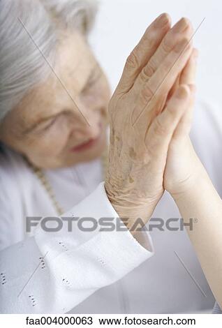 Elderly lady holding hand against grandchild's hand View Large Photo Image Stock Image - Elderly lady holding hand against grandchild's hand. Fotosearch