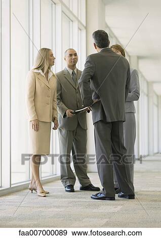 Executives talking in corridor View Large Photo Image Stock Photo - Executives talking in corridor. Fotosearch