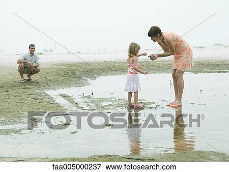 Stock Photo - Family at the beach. Fotosearch
