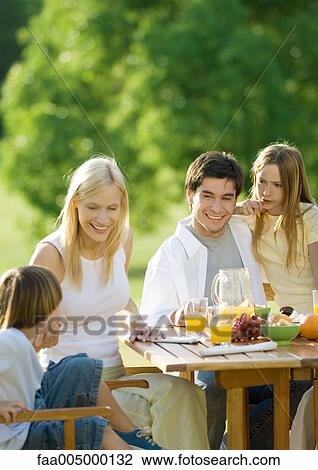 Family having breakfast outdoors View Large Photo Image Stock Image - Family having breakfast outdoors. Fotosearch