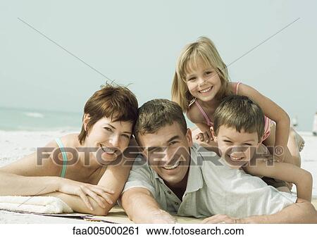 Family lying on beach, smiling, portrait View Large Photo Image Stock Image - Family lying on beach, smiling, portrait. Fotosearch